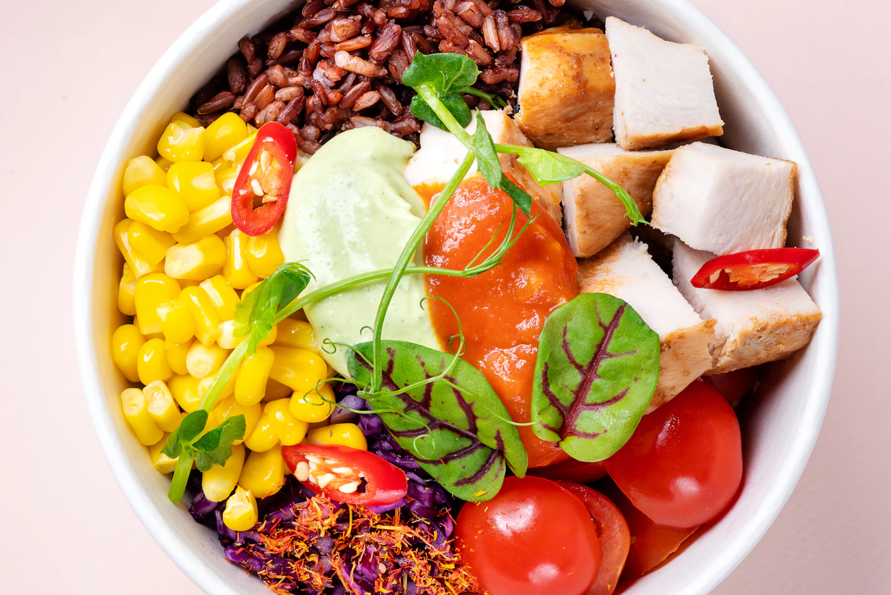 Build-your-own haystack bowl — beans, rice, tomatoes, corn, avocado and greens stacked high